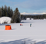 A family ice fish around their tent set up on Nimpo Lake.